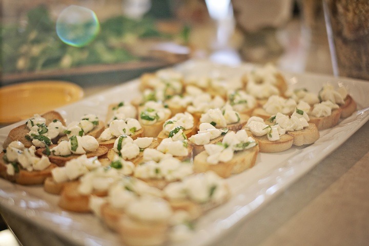 A white platter filled with Easy Mozzarella Lemon Basil Crostini