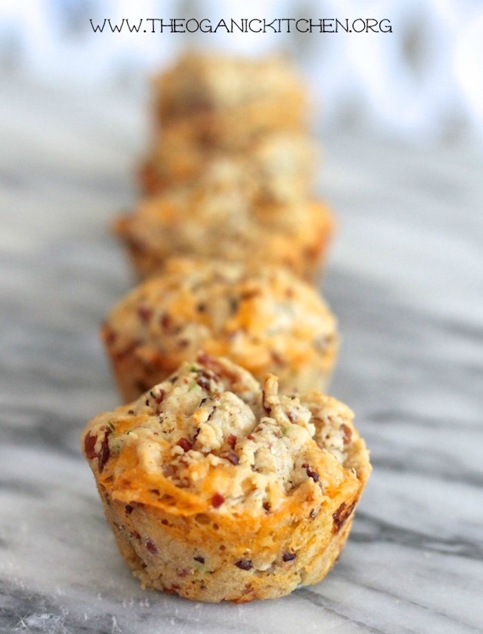 Five Cheddar Bacon Biscuits with Maple Cinnamon Butter lined up on a marble surface