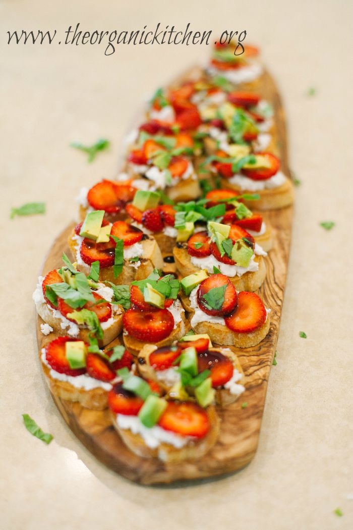 A platter of Strawberry and Avocado Bruschetta garnished with basil and balsamic glaze