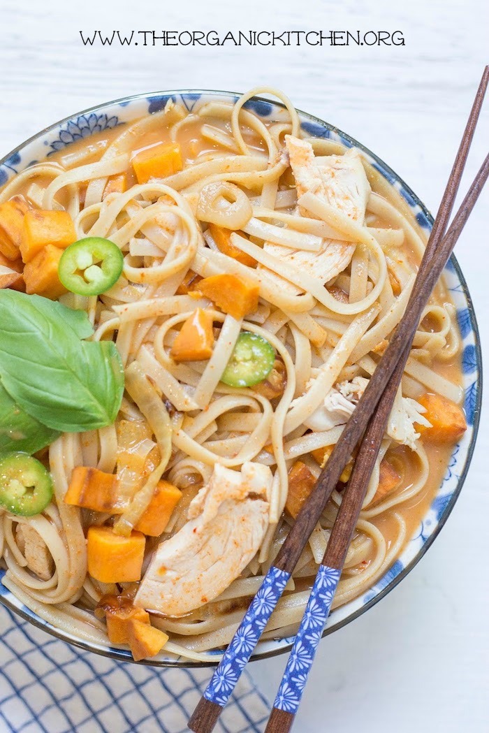 Chicken and Sweet Potato Asian Noodle Soup in blue and white bowl with chopsticks resting on top