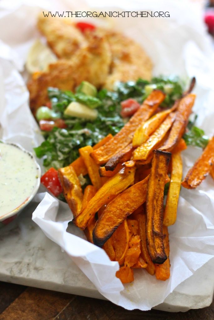 Rosemary Butternut Squash "Fries" with salad and chicken strips on white parchment paper