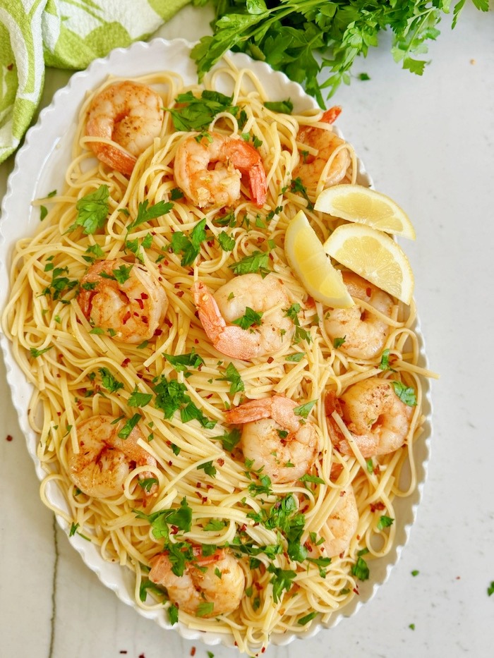 A platter filled with Easy Shrimp Scampi garnished with parsley and red pepper flakes