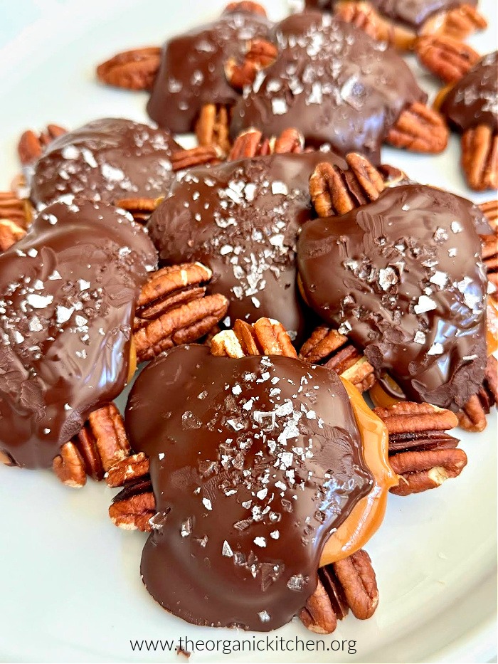 Easy Chocolate Pecan Turtles sprinkled with sea salt on white plate