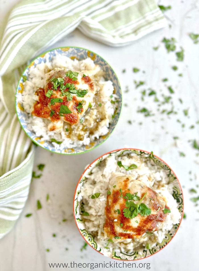 Two bowls of Easy Chicken Salsa Verde on white marble counter with green striped dish towel in background