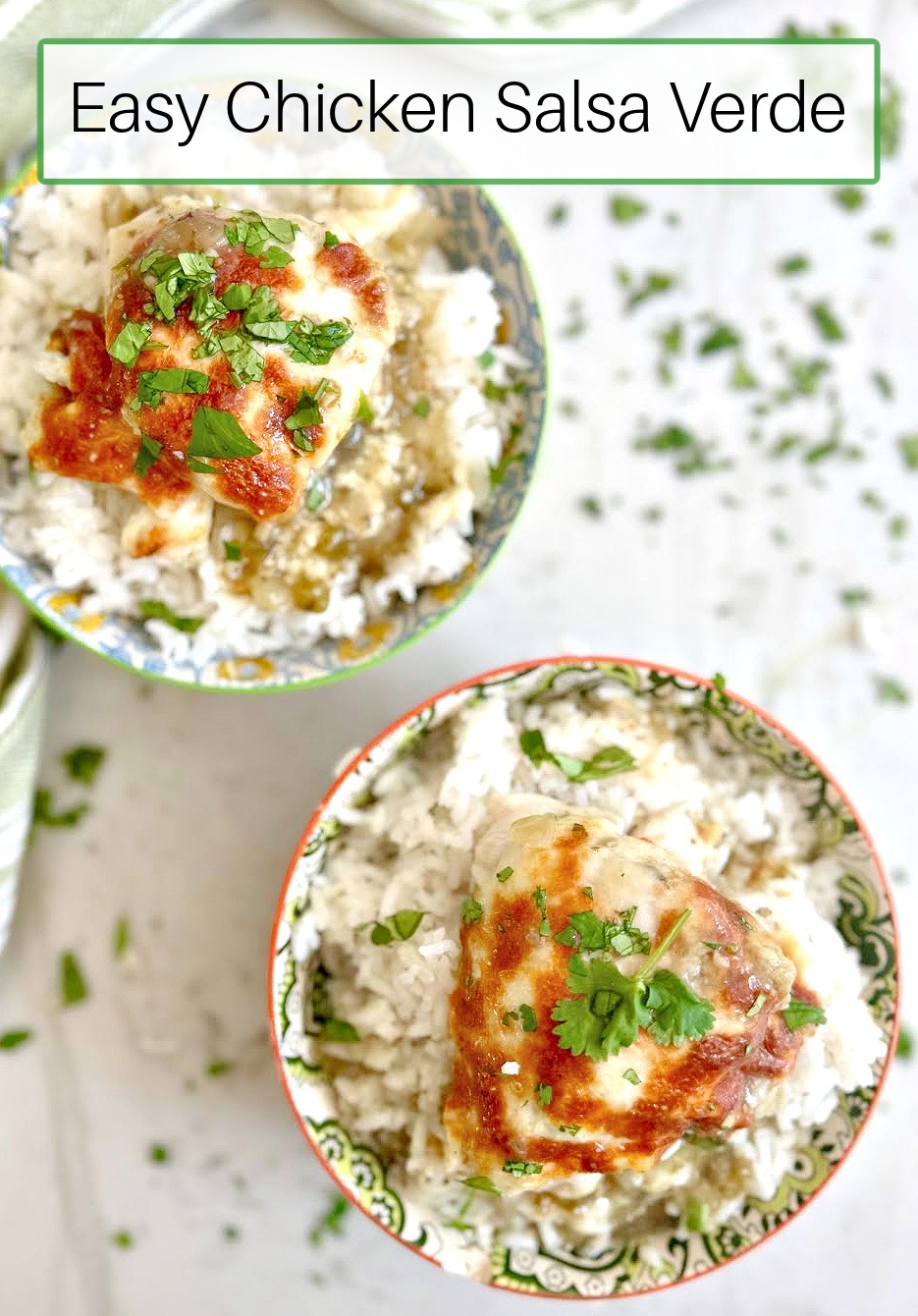 Two Bowls of Easy Chicken Salsa Verde over rive and garnished with chopped cilantro